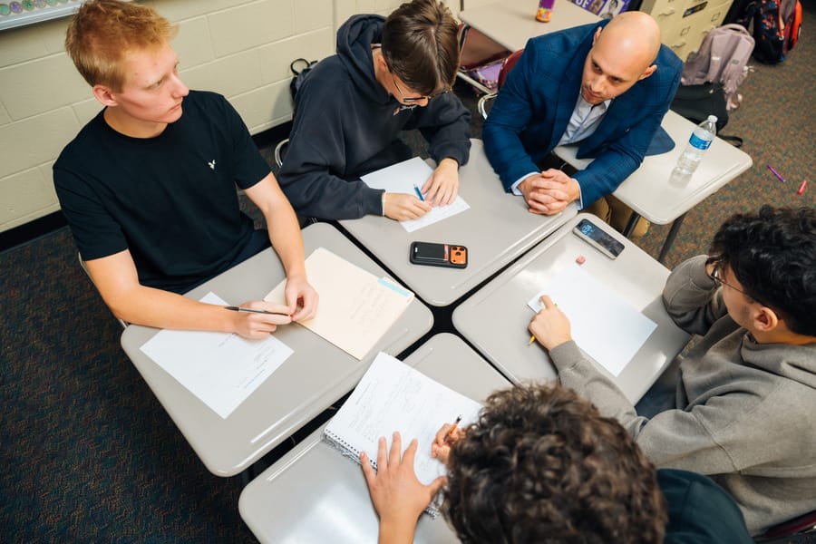 Students collaborating with an industry mentor during a SparkLab session