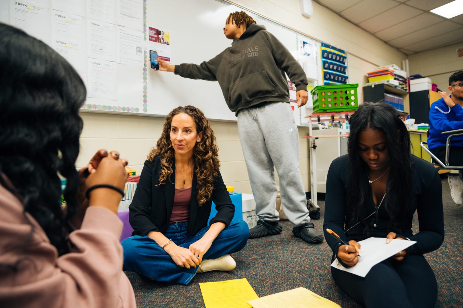 A SparkLab mentor working with students during a hands-on session
